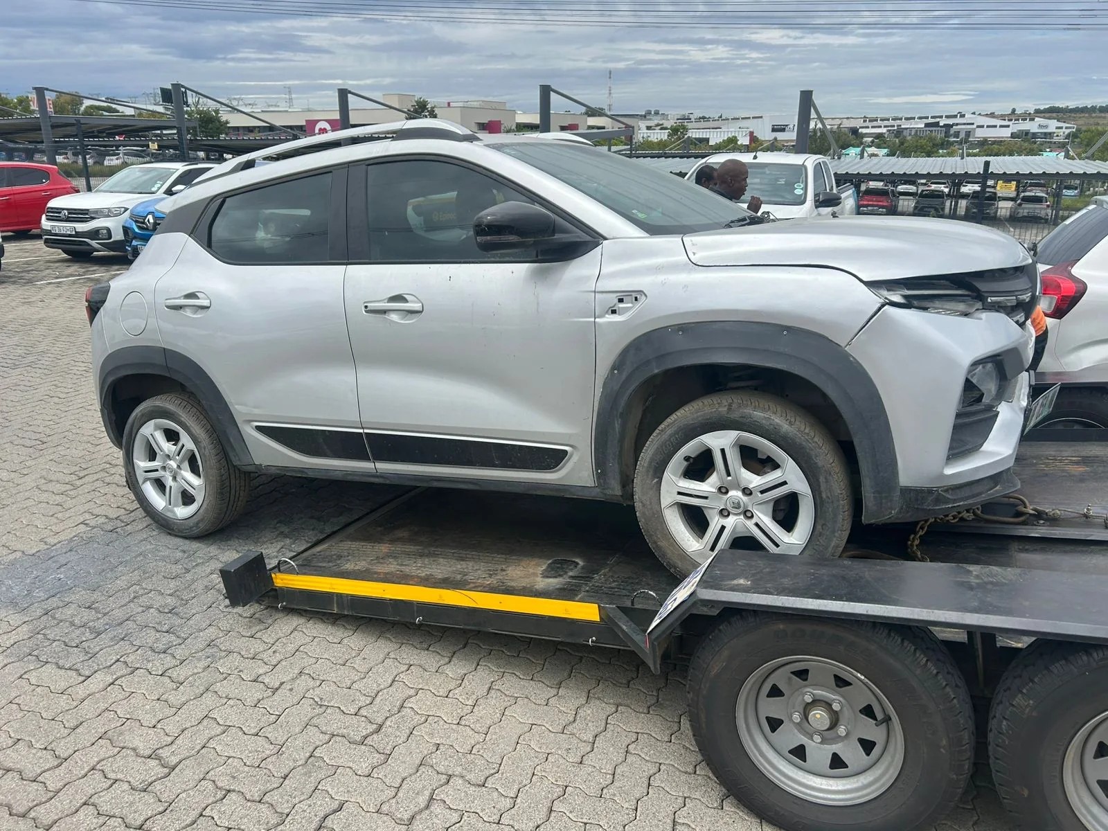 Damaged SUV being loaded onto a recovery bed