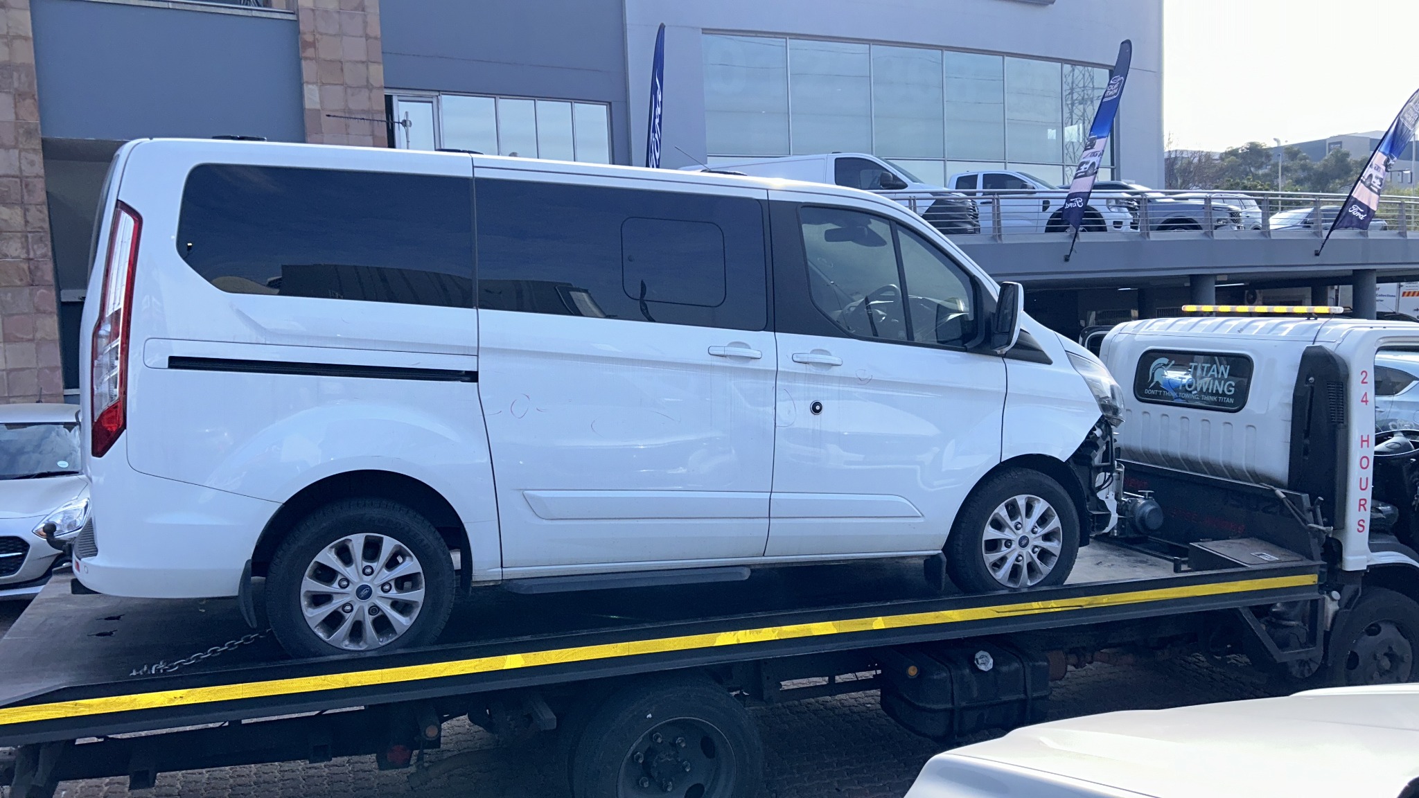 Titan Towing flatbed transporting a white van